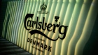 An illuminated logo sits on a wall at the Carlsberg A/S headquarters in Copenhagen, Denmark. Photographer: Carsten Snejbjerg/Bloomberg