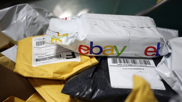 A parcel in eBay Inc. packaging is seen on a conveyor belt with other small parcels at the United States Postal Service. Photographer: Luke Sharrett/Bloomberg