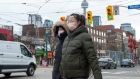 Pedestrians wear protective masks in Toronto