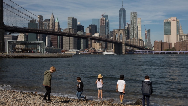 Children play at Pebble Beach in Main Street Park in the Brooklyn borough of New York, U.S., on Friday, Sept. 20, 2019. Slumping tech stocks dragged down U.S. indexes as traders moved on from a busy week for central bank meetings to shift their focus back to the trade war and geopolitical tensions. Photographer: Michael Nagle/Bloomberg