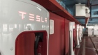 Electric vehicle charging stations stand in a Tesla Inc. Supercharger station in Shanghai, China