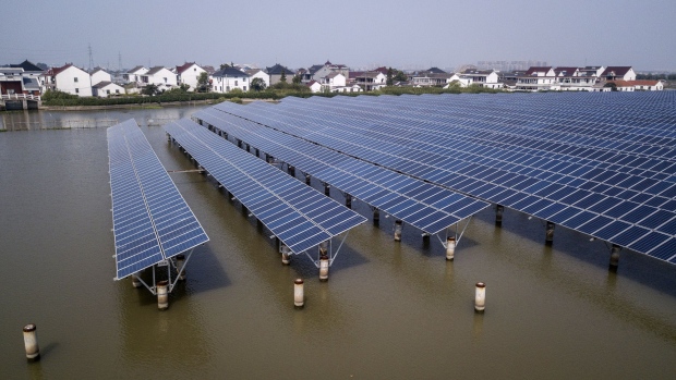 Photovoltaic panels stand at a solar farm operated by China Energy Conservation and Environmental Protection Group in this aerial photograph taken on the outskirts of Jiaxing, Zhejiang province, China, on Friday, Sept. 7, 2018. China is stepping up its push into renewable energy, proposing higher green power consumption targets and penalizing those who fail to meet those goals to help fund government subsidies to producers. Photographer: Qilai Shen/Bloomberg