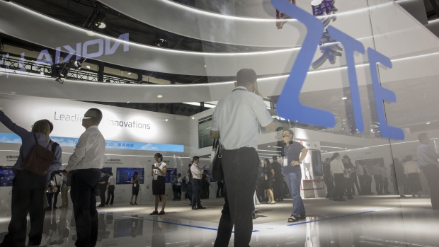 Attendees look at displays at the ZTE Corp. booth at the MWC Shanghai exhibition in Shanghai, China, on Thursday, June 27, 2019. The Shanghai event is modeled after a bigger annual industry show in Barcelona. Photographer: Qilai Shen/Bloomberg