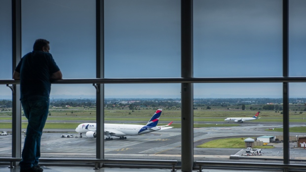 A South African Airways (SAA) passenger jet, right, prepares for take-off near an Airbus A-350-941, operated by LATAM Brasil, operated by LATAM Airlines Group, at O.R. Tambo International Airport in Johannesburg, South Africa, on Friday, Jan. 24, 2020. South African Airways said “time is of the essence” for the government to provide a pledged cash injection if the loss-making national carrier is to continue flying. 
