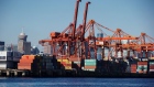 Gantry cranes stand over shipping containers at Port Metro Vancouver. 