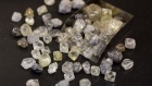 A collection of rough diamonds sit on a sorting table during processing at the United Selling Organisation (USO) of Alrosa PJSC sorting center in Moscow, Russia, on Tuesday, Feb. 12, 2019. 
