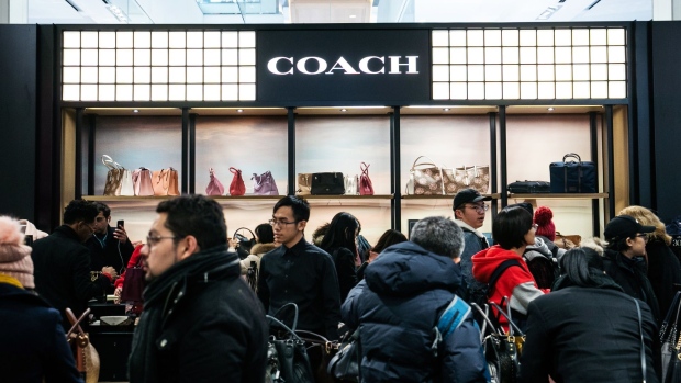 Shoppers browse Coach Inc. handbags at the Macy's Inc. flagship store in New York, U.S., on Thursday, Nov. 22, 2018. Deloitte expects sales from November to January to rise as much as 5.6 percent, to more than $1.1 trillion, marking the best holiday period in recent memory. Photographer: Jeenah Moon/Bloomberg