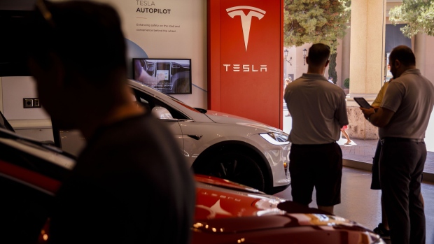 Customers browse vehicles at the Tesla Inc. showroom in Newport Beach, California, U.S., on Friday, July 6, 2018. Tesla Inc. reached a milestone critical to Elon Musk's goal to bring electric cars to the masses -- and earn some profit in the process -- by finally exceeding a long-sought production target with the Model 3. Photographer: Patrick T. Fallon/Bloomberg