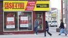 People walk pass a pay day loan store in Oshawa, Ont., May 13, 2017. THE CANADIAN PRESS