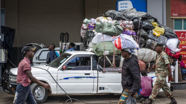 A delivery driver fills a truck loaded with goods at a gas station at the Beitbridge border station near the border crossing with Zimbabwe, near Musina, South Africa, on Tuesday, Dec. 17, 2019. Delivery drivers, or malaichas, a slang term meaning "deliverer of goods", transport items between South Africa's commercial hub, Johannesburg, and Zimbabwe’s capital, Harare. Photographer: Waldo Swiegers/Bloomberg