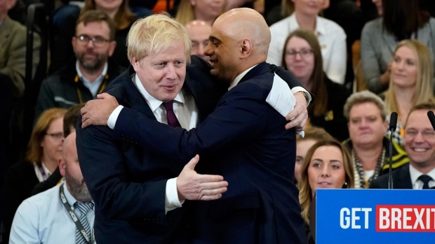UTTOXETER, ENGLAND - DECEMBER 10: Britain's Prime Minister and Conservative party leader embraces Sajid Javid, U.K. chancellor of the exchequer, following his speech during a general election campaign event at JCB construction company on December 10, 2019 in Uttoxeter, United Kingdom. The U.K will go to the polls in a general election on December 12. (Photo by Christopher Furlong/Getty Images)