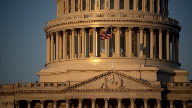 An American flag flies outside of the U.S. Capitol. Photographer: Andrew Harrer/Bloomberg