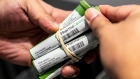 An employee holds PharmaCannis products at a store. Bloomberg/Jeenah Moon