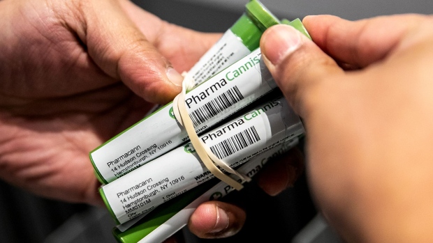 An employee holds PharmaCannis products at a store. Bloomberg/Jeenah Moon