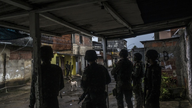 Soldiers stand guard in the Vila Kennedy neighborhood in Rio de Janeiro. Photographer: Dado Galdieri/Bloomberg