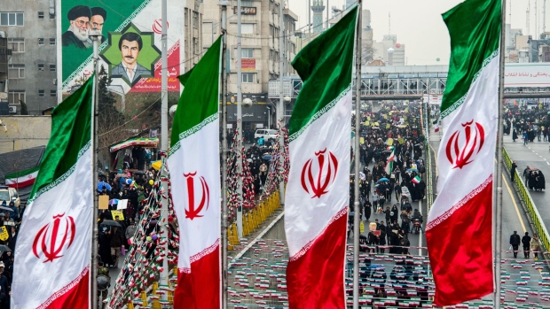 Demonstrators fill the street as Iranian national flag banners fly during the 40th anniversary of the Islamic revolution in Tehran, Iran, on Monday, Feb. 11, 2019. As Iran’s Islamic Republic enters a fifth decade, its energy industry has little to celebrate. Photographer: Ali Mohammadi/Bloomberg