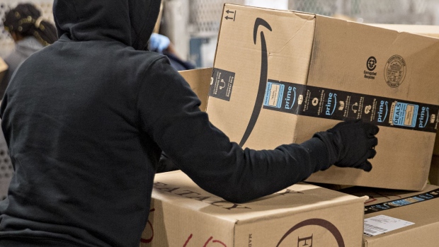 https://www.bnnbloomberg.ca/polopoly_fs/1.1390523.1581702285!/fileimage/httpImage/image.jpg_gen/derivatives/landscape_620/an-employee-moves-an-amazon-com-inc-package-for-delivery-at-the-united-states-postal-service-usps-joseph-curseen-jr-and-thomas-morris-jr-processing-and-distribution-center-in-washington-d-c-u-s-on-tuesday-dec-12-2017-the-usps-said-it-expects-to-deliver-over-15-billion-total-pieces-of-mail-this-holiday-season-with-expanded-sunday-delivery-operations-in-certain-areas-delivering-over-six-million-packages-each-sunday-in-december-photographer-andrew-harrer-bloomberg.jpg
