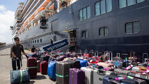 SIHANOUKVILLE - FEBRUARY 14 : Cruise passengers luggage gets unloaded from the MS Westerdam cruise ship after being stranded for two weeks, now docked on February 14, 2020 in Sihanoukville, Cambodia. The ship is completely free from the Coronavirus (COVID-19.) but was turned away from five other Asian ports, it departed Hong Kong February 1st with 1,455 passengers and 802 crew on board. Another cruise ship is in quarantine in Japan with more than 200 infections. The Coronavirus cases rise to more than 64,000 people, total number of deaths is approximately 1,383. (Photo by Paula Bronstein/Getty Images)