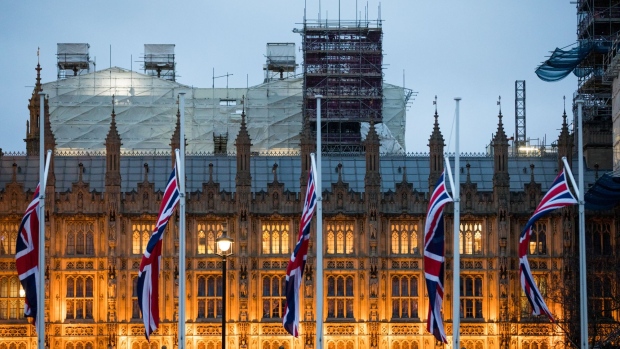 Union flags fly in front of the Houses of Parliament. Photographer: Chris Ratcliffe/Bloomberg