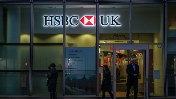 A sign featuring a HSBC Holdings Plc logo hangs outside a bank branch in London, U.K., on Wednesday, Nov. 6, 2019. The U.K. is headed to the polls on Dec. 12, bringing banks, utilities and housebuilders into focus for U.K. equity investors. Photographer: Hollie Adams/Bloomberg