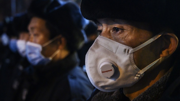 BEIJING, CHINA - FEBRUARY 09: A Chinese security guard wears a protective mask as he lines up with others on February 9, 2020 in Beijing, China. The number of cases of a deadly new coronavirus rose to more than 37000 in mainland China Sunday, days after the World Health Organization (WHO) declared the outbreak a global public health emergency. China continued to lock down the city of Wuhan in an effort to contain the spread of the pneumonia-like disease which medicals experts have confirmed can be passed from human to human. In an unprecedented move, Chinese authorities have put travel restrictions on the city which is the epicentre of the virus and municipalities in other parts of the country affecting tens of millions of people. The number of those who have died from the virus in China climbed to over 810 on Sunday, mostly in Hubei province, and cases have been reported in other countries including the United States, Canada, Australia, Japan, South Korea, India, the United Kingdom, Germany, France and several others. The World Health Organization has warned all governments to be on alert and screening has been stepped up at airports around the world. Some countries, including the United States, have put restrictions on Chinese travelers entering and advised their citizens against travel to China. (Photo by Kevin Frayer/Getty Images) Photographer: Kevin Frayer/Getty Images AsiaPac