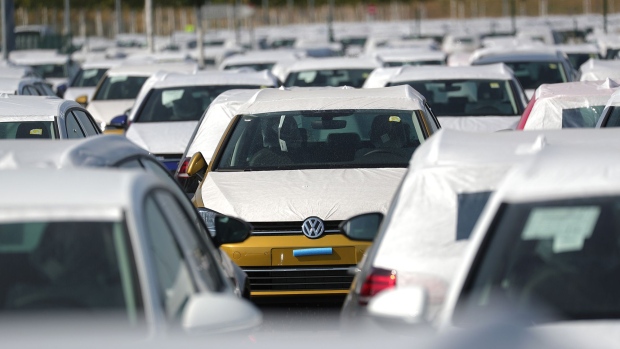 A Volkswagen AG (VW) Golf automobile, center, sits with other VW cars in a parking lot at Willy Brandt Berlin Brandenburg International Airport in Schoenefeld, Germany, on Friday, Aug. 17, 2018. 