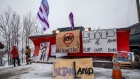 Signs hang from a snowplow during a protest near Belleville, Ontario, Canada, on Thursday, Feb. 13, 2020. Demonstrators have been disrupting railroads and other infrastructure across Canada for more than a week to protest TC Energy Corp.'s planned C$6.6 billion ($5 billion) Coastal GasLink pipeline. Photographer: Brett Gundlock/Bloomberg