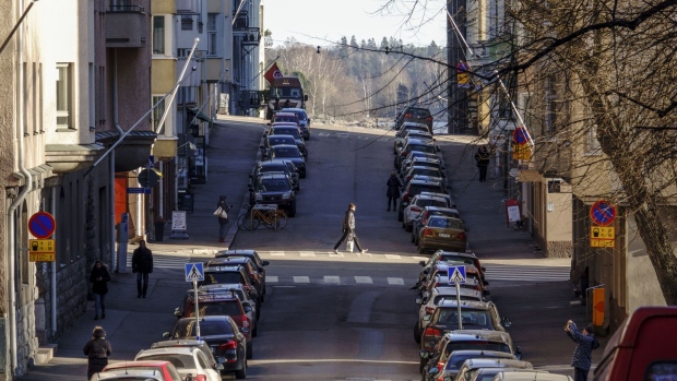 A pedestrian crosses the road in the Kruunuhaka district of Helsinki, Finland, on Thursday, Feb. 6, 2020. Finnish household debt has doubled in the past two decades against a backdrop of falling interest rates and the gradual obsolescence of cash as a form of payment. Photographer: Maija Astikainen/Bloomberg