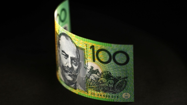 An Australian one hundred dollar banknote is arranged for a photograph in Sydney, Australia, on Wednesday, May 23, 2018. Australia's central bank chief Philip Lowe said last week that his nation and China together can be a force supportive of an open global trading system. Photographer: Brendon Thorne/Bloomberg