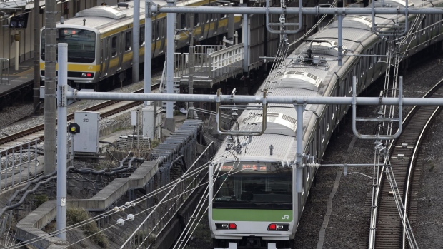 East Japan Railway Co. (JR East) trains travel along railway tracks in Tokyo, Japan, on Thursday, March 23, 2017. JR East, the world’s largest listed passenger rail operator, is offering to help improve on-time performance and service at train stations as part of its joint bid for a franchise to manage the West Midlands train service in the U.K., President Tetsuro Tomita said during an interview Thursday. Photographer: Kiyoshi Ota/Bloomberg