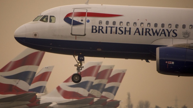 A passenger aircraft operated by British Airways, a unit of International Consolidated Airlines Group SA (IAG), lands at London Heathrow Airport in London, U.K., on Monday, Dec. 24, 2018. British Airways-owner International Consolidated Airlines Group SA and budget carriers EasyJet Plc and Ryanair Holdings Plc all have significant revenue exposure to the U.K., according to analysts at Bernstein. Photographer: Jason Alden/Bloomberg