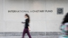 Pedestrians walk past the International Monetary Fund (IMF) headquarters in Washington, D.C., U.S., on Tuesday, Sept. 4 2018. 