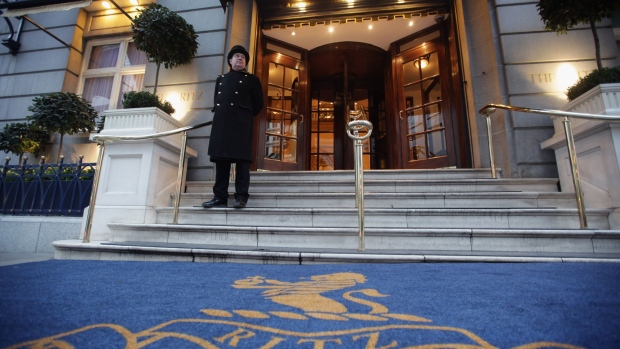 A doorman stands at the entrance to The Ritz Hotel, London.