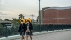 TOKYO, JAPAN - FEBRUARY 28: Schoolgirls wearing face masks and novelty hats leave Tokyo Disneyland on the day it announced it will close until March 15th because of concerns over the Covid-19 virus, on February 28, 2020 in Tokyo, Japan. 
