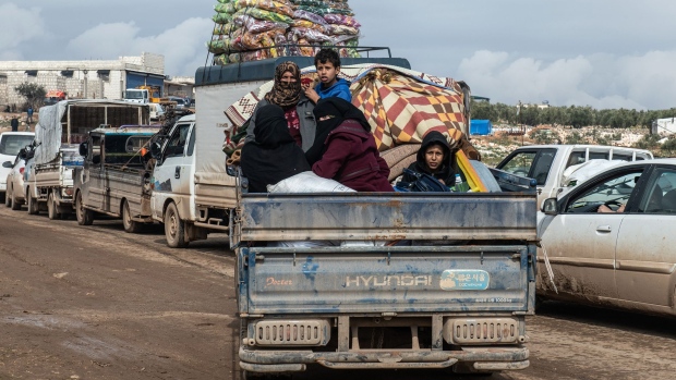 Displaced Syrian families ride in the back of a truck in Idlib, Syria on Feb. 22.
