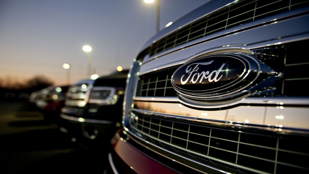 A Ford Motor Co. emblem appears on the grille of a 2014 F-150 pickup truck on display at Uftring Ford in East Peoria, Illinois, U.S., on Saturday, Nov. 30, 2013. Photographer: Daniel Acker