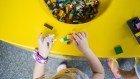 A child plays inside the Lego A/S store at the Walt Disney Co. Disney Springs entertainment complex in Orlando, Florida, U.S., on Tuesday, Sept. 19, 2017. Bloomberg is scheduled to release consumer comfort figures on October 5. Photographer: Cassi Alexandra/Bloomberg