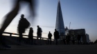 Commuters walk across London Bridge in view of the Shard in London, U.K., on Friday, Nov. 8, 2019. Living standards in the U.K. are on the cusp of returning to their pre-crisis levels in an election boost for Prime Minister Boris Johnson. Photographer: Simon Dawson/Bloomberg