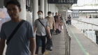 Travelers head towards the thermal screening station at the Singapore Cruise Centre in Singapore, on Thursday, March 5, 2020