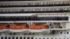 Passengers looks out from balconies on the Carnival Corp. Panorama cruise ship sits docked in Long Beach, California, U.S., on Saturday, March 7, 2020. 