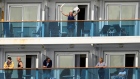 A passenger waves aboard the Grand Princess off the coast of San Francisco