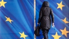 An employee enters sliding doors decorated with the stars of the European Union (EU) flag at the Berlaymont building, headquarters of the European Commission (EC), in Brussels, Belgium, on Tuesday, Jan. 28, 2020. 