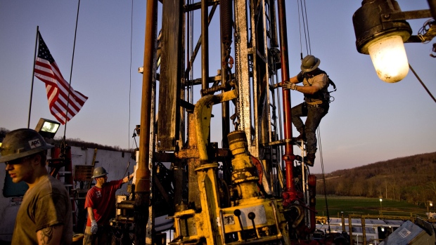 Nomac Drilling Corp. derrick man Justin Spruell, right, climbs down from an overhead platform after connecting a section of drill pipe on a Chesapeake Energy Corp. natural gas drill site in Bradford County, Pennsylvania, U.S., on Tuesday, April 6, 2010.