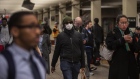 A commuter wears a mask while walking through a subway station in New York, U.S., on Monday, March 9, 2020. 