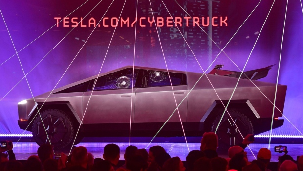 People take pictures of the newly unveiled all-electric battery-powered Tesla's Cybertruck with shattered windows after a failed resistance test, at Tesla Design Center in Hawthorne, California on November 21, 2019.