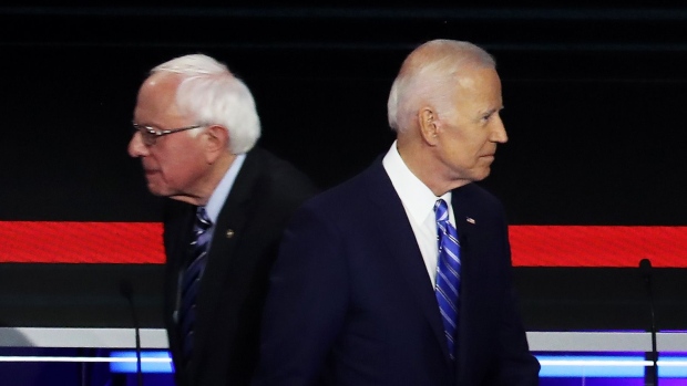 MIAMI, FLORIDA - JUNE 27: Democratic presidential candidates Sen. Bernie Sanders (L) (I-VT) and former Vice President Joe Biden pass each other on stage during the second night of the first Democratic presidential debate on June 27, 2019 in Miami, Florida. A field of 20 Democratic presidential candidates was split into two groups of 10 for the first debate of the 2020 election, taking place over two nights at Knight Concert Hall of the Adrienne Arsht Center for the Performing Arts of Miami-Dade County, hosted by NBC News, MSNBC, and Telemundo. (Photo by Drew Angerer/Getty Images)