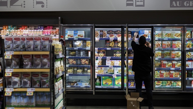 An employee stocks a freezer inside a Metro Inc. grocery store in Toronto, Ontario, Canada, on Monday, Oct. 2, 2017.