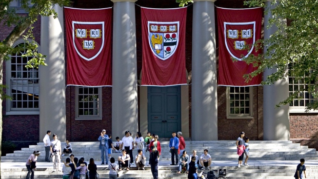 Harvard banners hang outside Memorial Church on the Harvard University campus in Cambridge, Massachusetts. Photographer: Michael Fein/Bloomberg