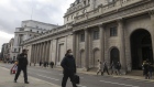 A pedestrian wearing a protective face mask walks past the the Bank of England, in the City of London, U.K., on Tuesday, March 3, 2020. Andrew Bailey's tenure as BOE Governor starts when concerns about the coronavirus have sparked a flurry of speculation that central banks around the world will start emergency policy easing. Photographer: Simon Dawson/Bloomberg