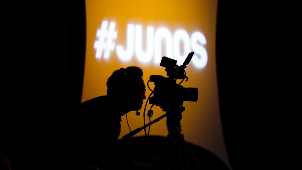 A videographer looks through his camera during the 2020 Juno Award 